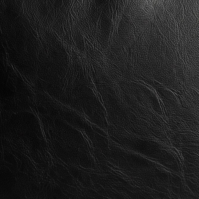 Close-up of black vegan leather fabric texture showing natural grain and wrinkle pattern