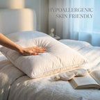 Hypoallergenic white down alternative pillow insert on a clean white bed with a hand gently touching it. Skin-friendly...