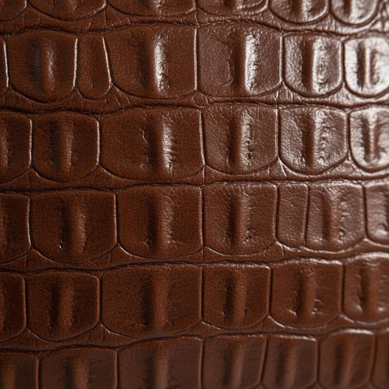 Macro detail of crocodile embossed pattern on premium vegan leather pillow cover