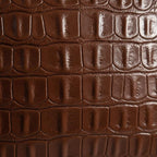 Macro detail of crocodile embossed pattern on premium vegan leather pillow cover