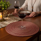 Wine braided round jute placemat styled with wine glass on wooden dining table for evening setting – Larissa Home Decor