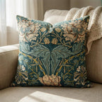 Teal William Morris botanical velvet pillow cover styled on cream armchair with knit throw