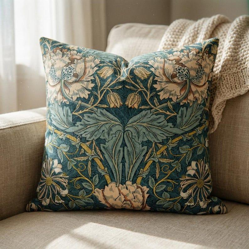 Teal William Morris botanical velvet pillow cover styled on cream armchair with knit throw