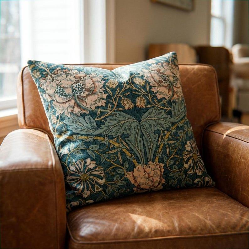 Luxury William Morris botanical print velvet throw pillow cover in teal on leather armchair