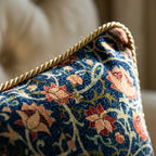Close-up of gold braided rope trim on William Morris velvet throw pillow cover with coral and navy floral pattern