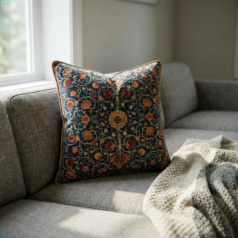 William Morris botanical velvet throw pillow cover on a grey sofa, intricate scrolling vine and floral print with gold rope trim
