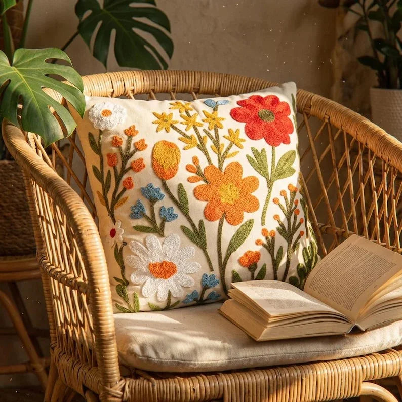 Wildflower embroidered throw pillow cover on rattan chair with monstera plant — boho cottagecore decor