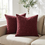 Set of 2 burgundy chenille throw pillow covers styled on a beige sofa in a bright living room