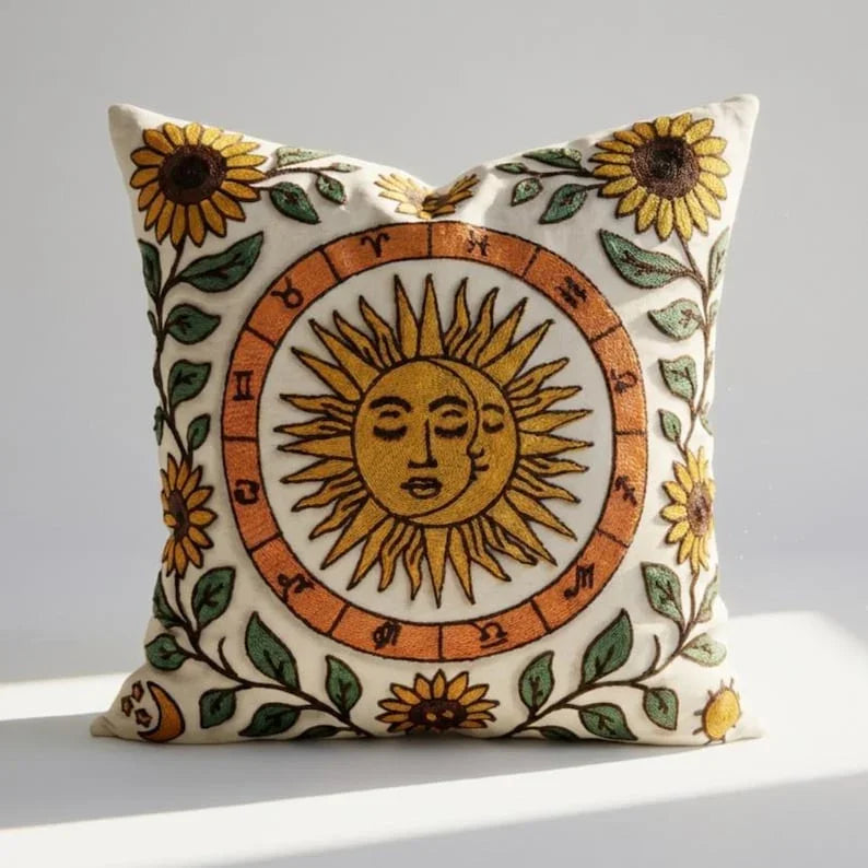 Handcrafted embroidered celestial sun zodiac throw pillow cover on off-white cotton canvas with sunflower vine motifs