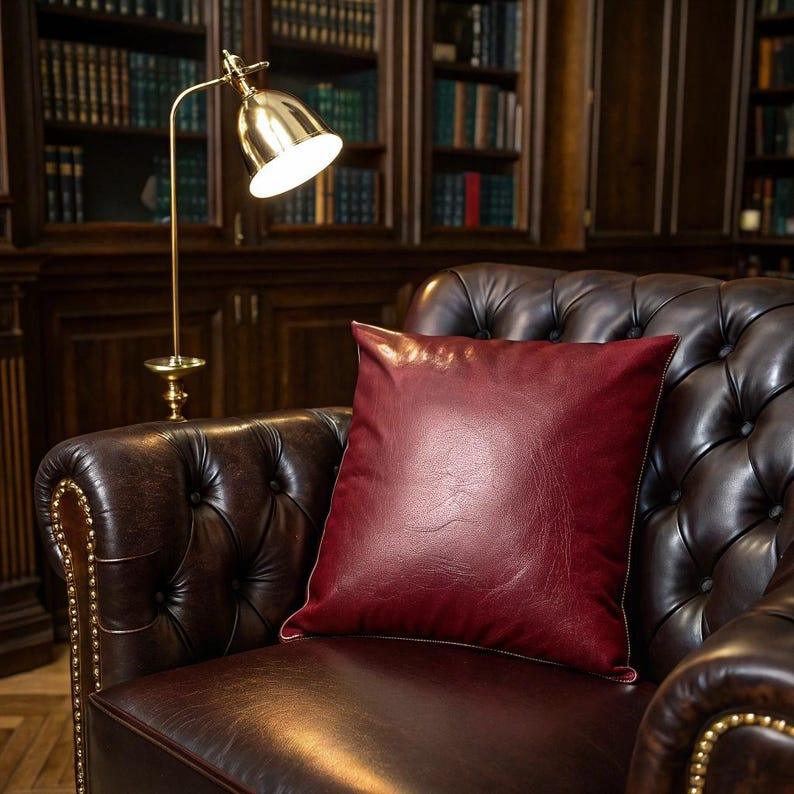 Side angle of burgundy vegan leather pillow cover highlighting material sheen and structure