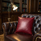Side angle of burgundy vegan leather pillow cover highlighting material sheen and structure