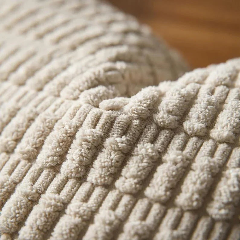 Close-up of beige corduroy wide-wale ribbed fabric texture detail