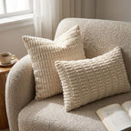 Set of 2 beige corduroy pillow covers styled on a boucle armchair in a cozy living room