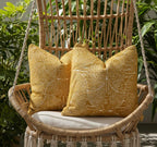 Woven chair with yellow patterned cushions in a natural setting