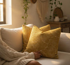 Yellow textured pillows on a couch in a cozy living room with plants and decor.