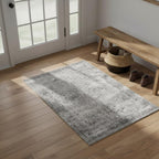 Gray washable vintage distressed area rug styled in entryway on hardwood floor with farmhouse bench and woven basket