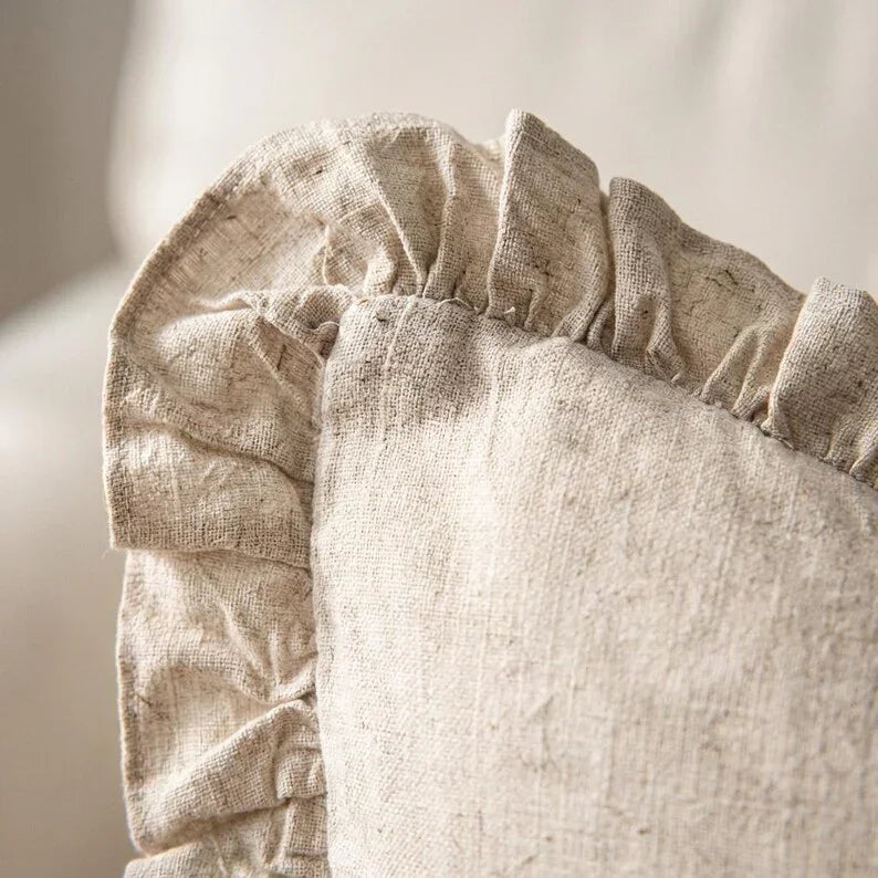 Close-up of gathered ruffle border on 100% linen pillow cover in natural beige