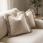 Set of 2 linen ruffle pillow covers on a white sofa in a farmhouse-style living room
