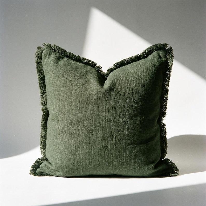 Single olive green linen fringe pillow cover showing full fringe edge detail and relaxed woven texture