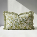 Floral hand block print bolster pillow cover in sage green and teal with gathered striped ruffle trim on white background