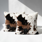 Set of 2 vegan cowhide faux fur throw pillow covers in brown and white, square size, styled on white background