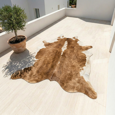 Vegan leather cowhide rug in brown and white displayed on light tile floor outdoors – Larissa Home Decor