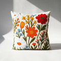 Handcrafted wildflower embroidered pillow cover on white background — cottagecore floral cotton canvas