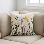 Embroidered hummingbird wildflower pillow cover styled on a beige sofa in a bright living room