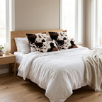 Vegan cowhide faux fur throw pillow covers set of 2 styled on white bed in modern bedroom
