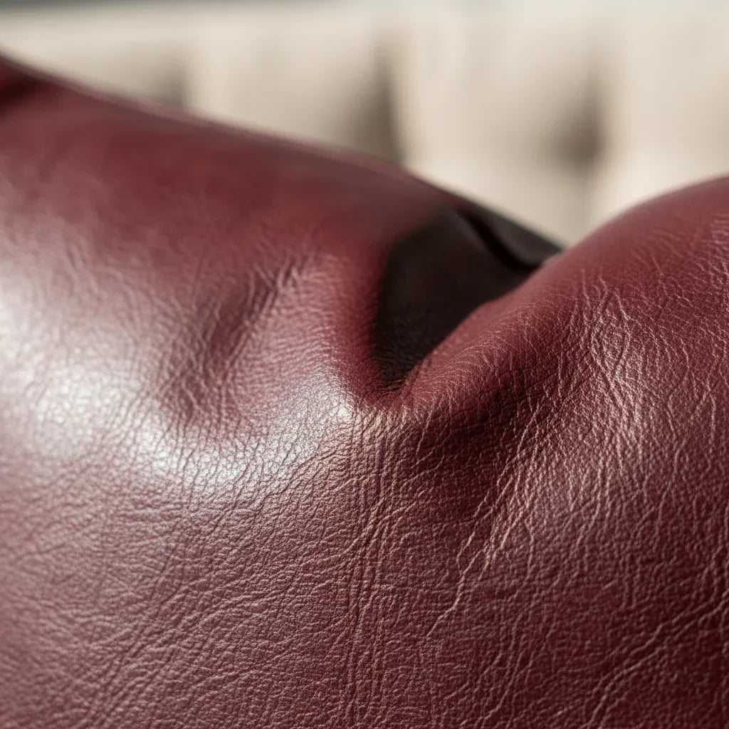 Macro close-up of pebbled faux leather texture in deep burgundy color