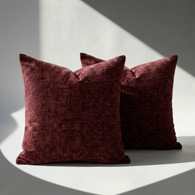 Set of 2 burgundy chenille throw pillow covers with plush velvet-like texture on a white surface