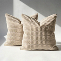 Set of 2 beige corduroy throw pillow covers with wide-wale ribbed texture on white surface