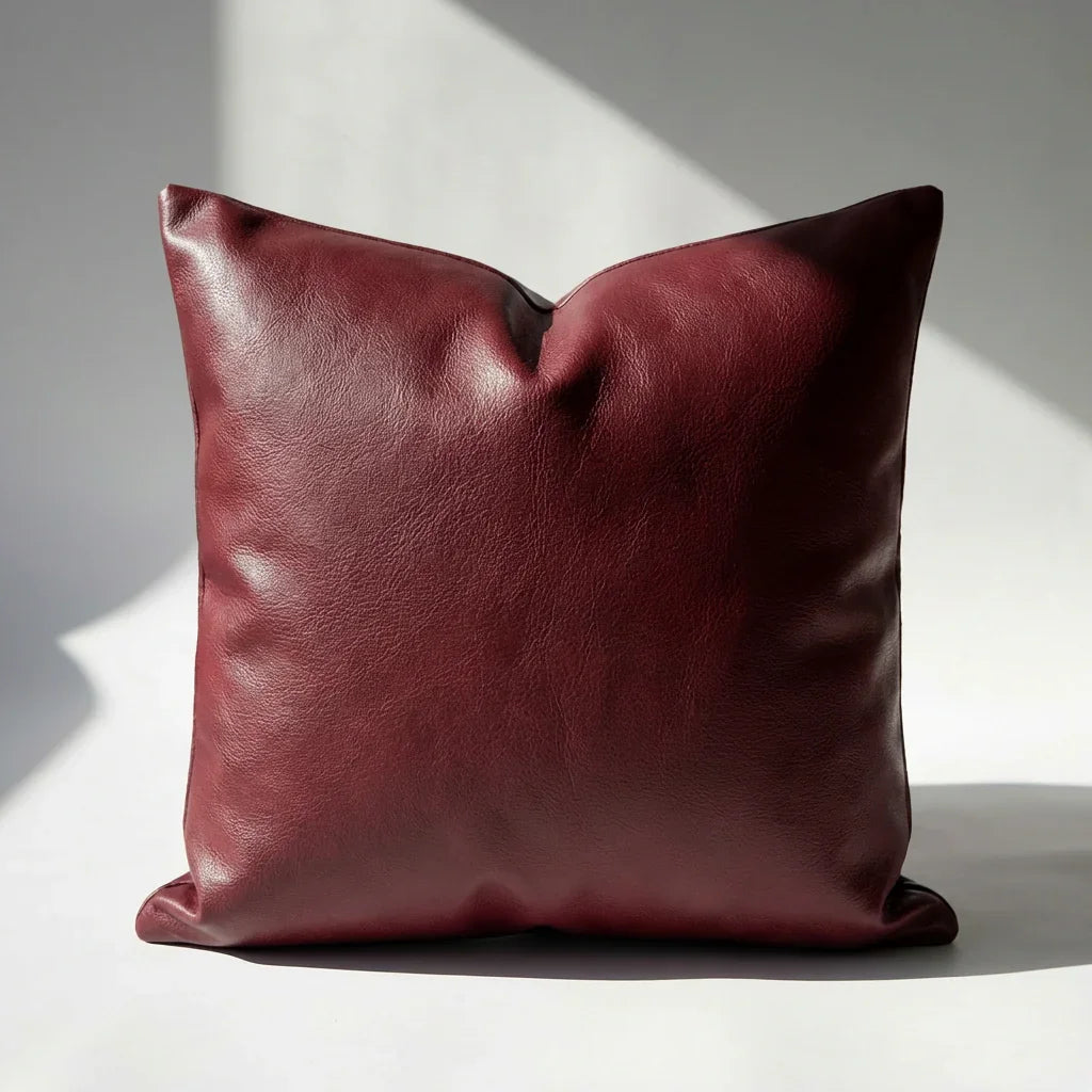 Single burgundy faux leather pillow cover, smooth pebbled texture, square shape