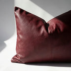 Close-up of burgundy vegan leather pillow cover corner showing hidden zipper detail
