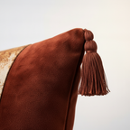 Corner tassel detail on rust terracotta velvet pillow cover with tapestry Klimt artwork
