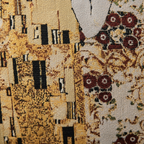 Close-up of woven tapestry art panel on Gustav Klimt The Kiss pillow cover showing gold and burgundy detail