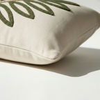 Side profile of cream lumbar pillow cover with hidden zipper closure and punch needle design