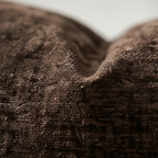 Macro detail of brown chenille fabric showing looped plush texture and subtle sheen – Larissa Home Decor