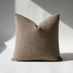 Single brown boucle pillow cover with dense looped texture, square shape, studio shot