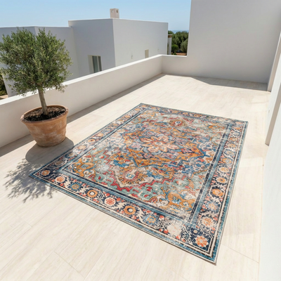 Boho medallion washable area rug in multicolor blue and gold displayed on an outdoor terrace