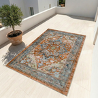 Persian-style vintage medallion area rug with floral pattern in warm rust tones displayed on a light stone floor